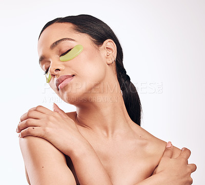 Buy stock photo Studio shot of a beautiful young woman wearing a gel eye mask while standing against a white background