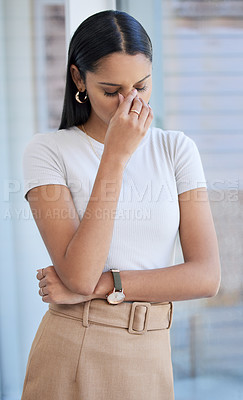 Buy stock photo Cropped shot of an attractive young businesswoman looking stressed while standing in her office