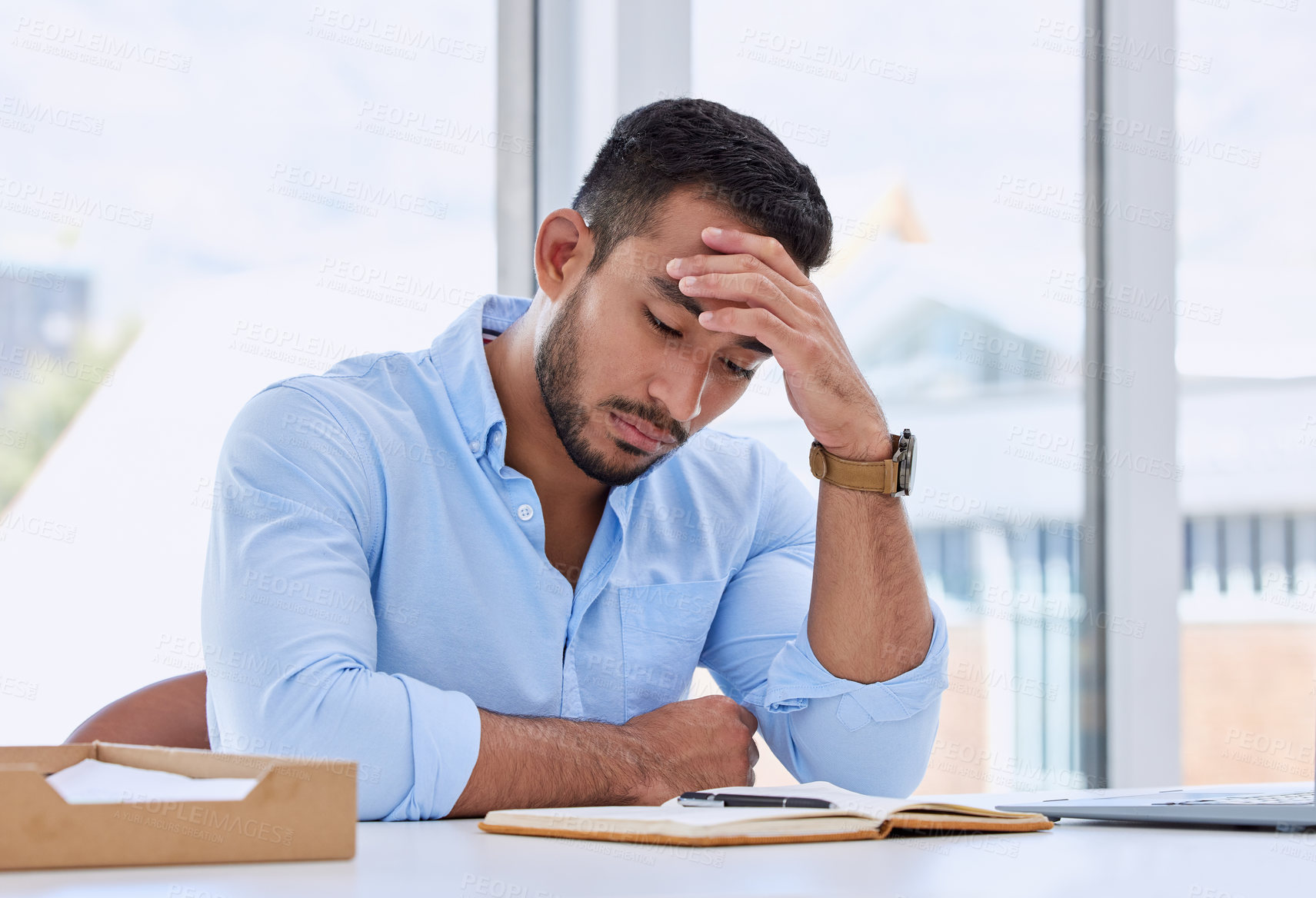 Buy stock photo Shot of a young businessman in his office