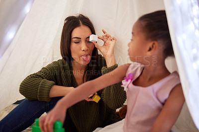 Buy stock photo Blanket, fort and mother play with girl for bonding, quality time and child development at home. Fun family, relax and happy mom with child playing with educational toys, building blocks and shapes