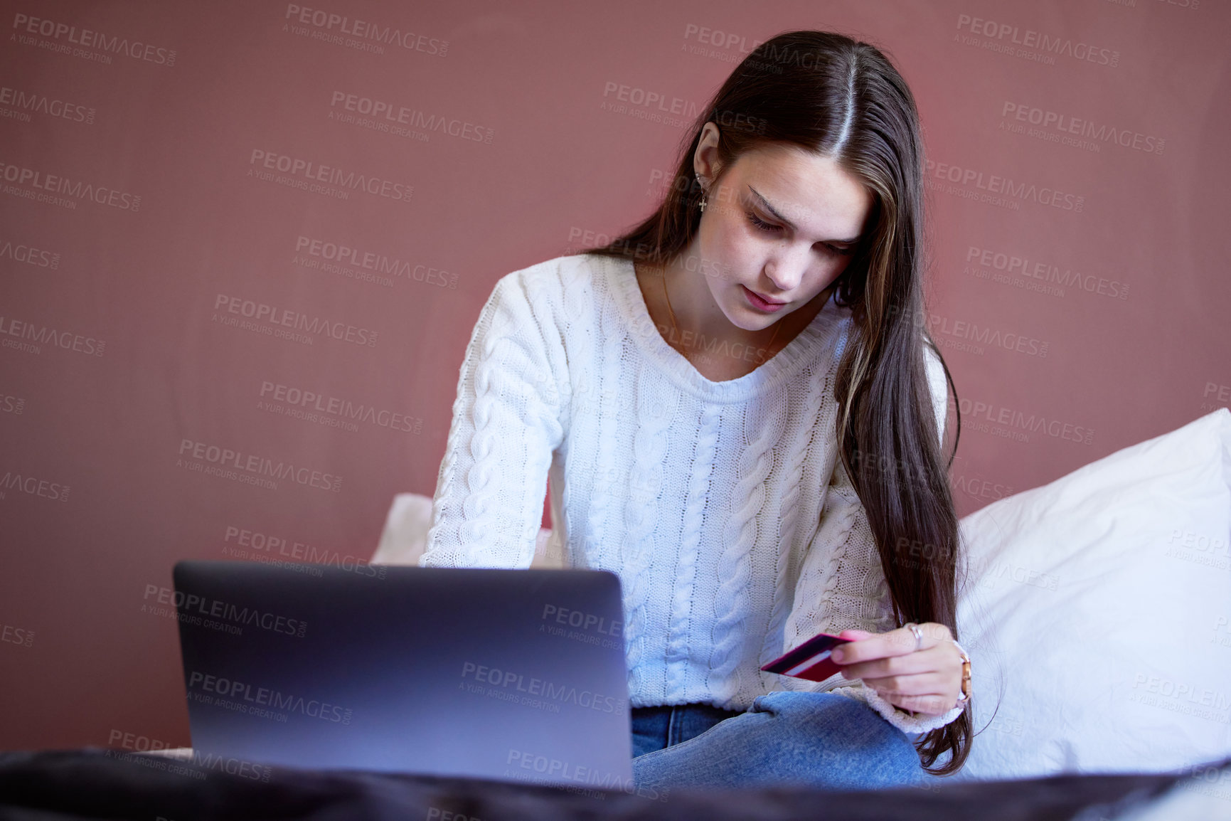 Buy stock photo Shot of a young woman shopping online using her laptop