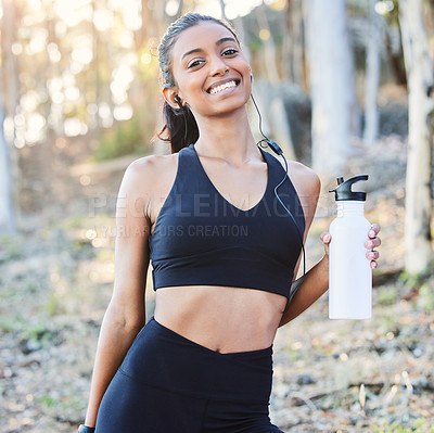 Buy stock photo Fitness, nature or portrait of happy woman drinking water in training, running exercise or workout for wellness. Runner, bottle or healthy sports girl on break in park with smile or music headphones 