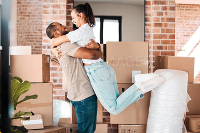 Buy stock photo Shot of a couple looking cheerful while moving into their new home