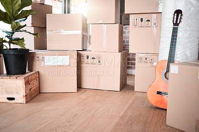 Buy stock photo Interior, storage and box by plant in new house, apartment or property for moving, relocating or purchase a home. Shipping, real estate or mortgage for renovation with guitar in space, lounge or room