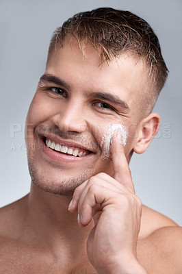 Buy stock photo Grooming, cream and portrait of man in studio with moisturizer for dermatology, wellness or treatment on gray background. Hygiene, smile and male model with lotion for skincare, routine or product