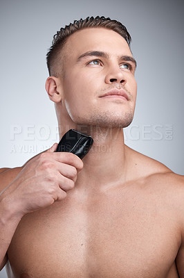 Buy stock photo Razor, shave and machine with man in studio, skincare and hygiene for facial grooming. Cosmetic, hair removal and wellness for dermatology, maintenance and electric cleaning tool on background