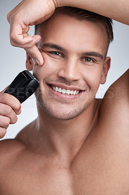 Buy stock photo Portrait, man and studio with electric razor, skincare and hygiene for facial grooming. Cosmetic, hair removal and happy for dermatology or wellness, maintenance and shaving tool on background