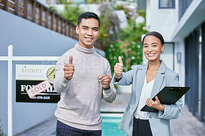 Buy stock photo Shot of a young female real estate agent and a male client showing a thumbs up