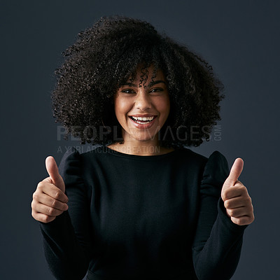 Buy stock photo Shot of a young businesswoman giving the thumbs up against a studio background