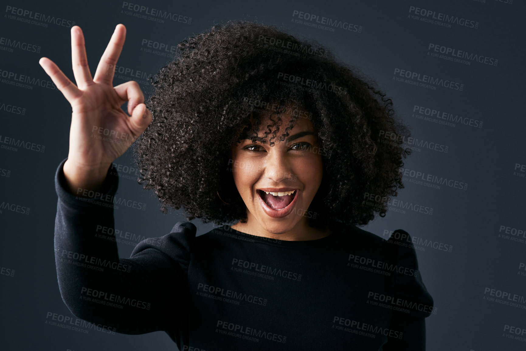 Buy stock photo Shot of a young businesswoman making hand gestures against a studio background