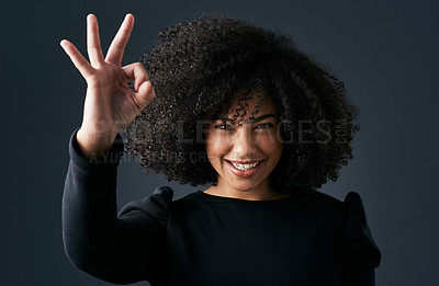 Buy stock photo Shot of a young businesswoman making hand gestures against a studio background