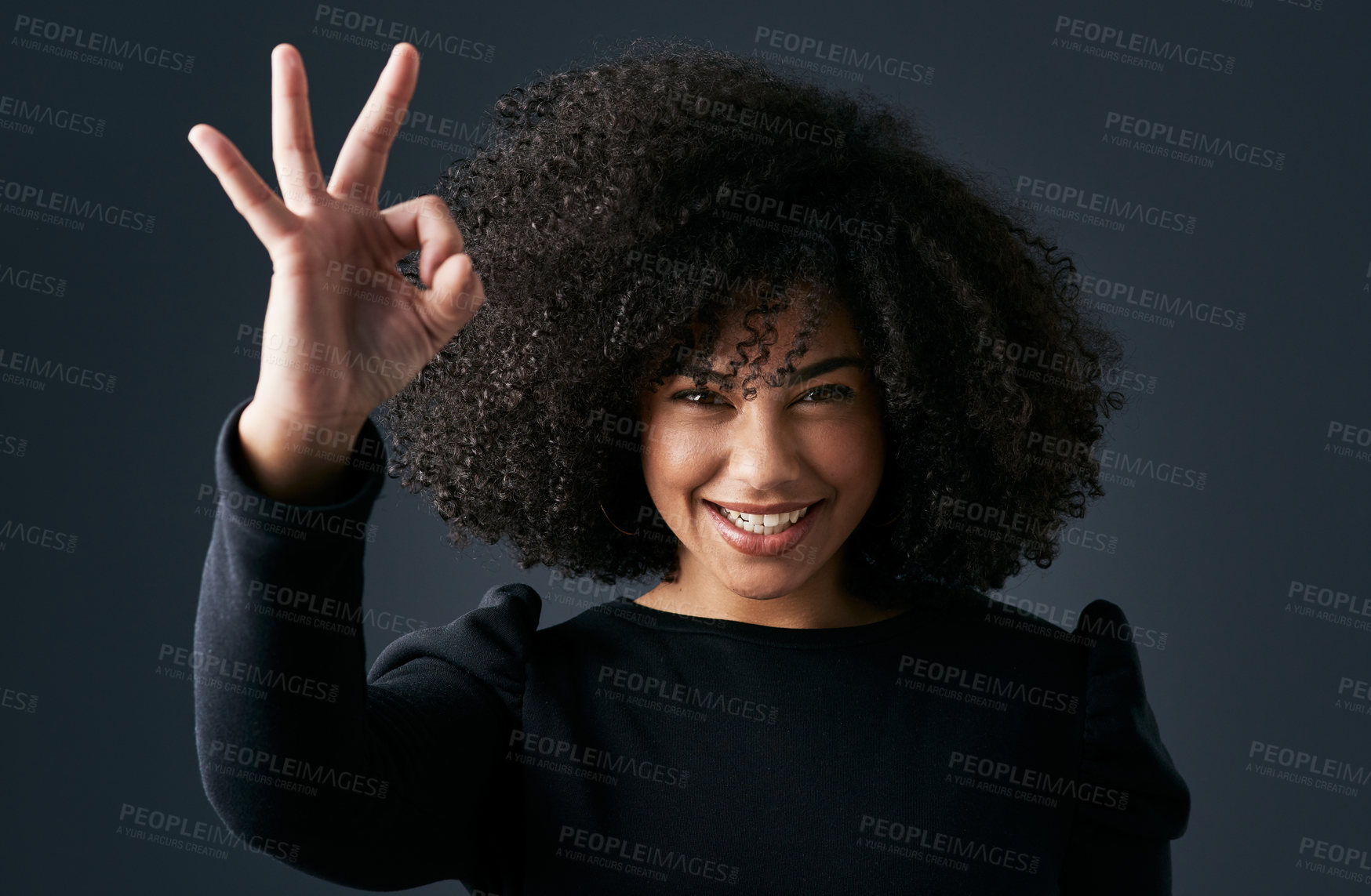 Buy stock photo Shot of a young businesswoman making hand gestures against a studio background