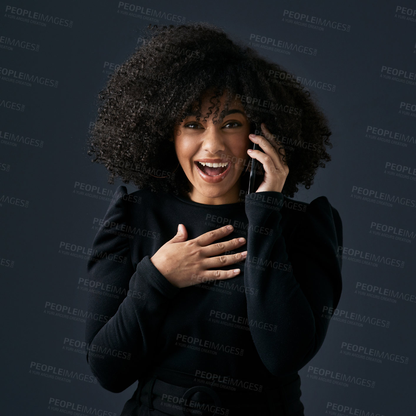 Buy stock photo Shot of a young businesswoman using her smartphone against a studio background