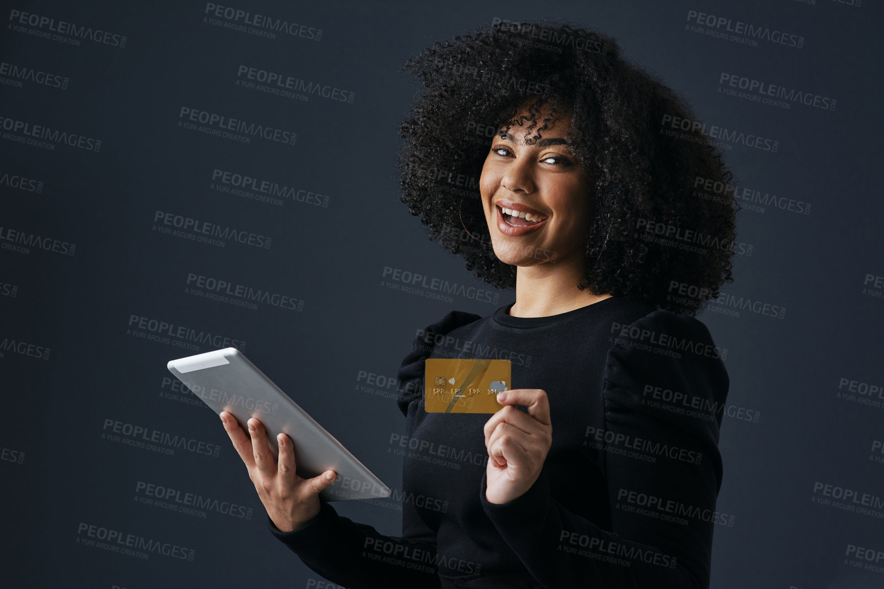Buy stock photo Shot of a businesswoman using her tablet to shop online against a studio background