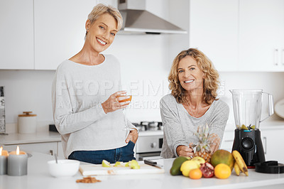 Buy stock photo Shot of two friends having juice and smoothies together