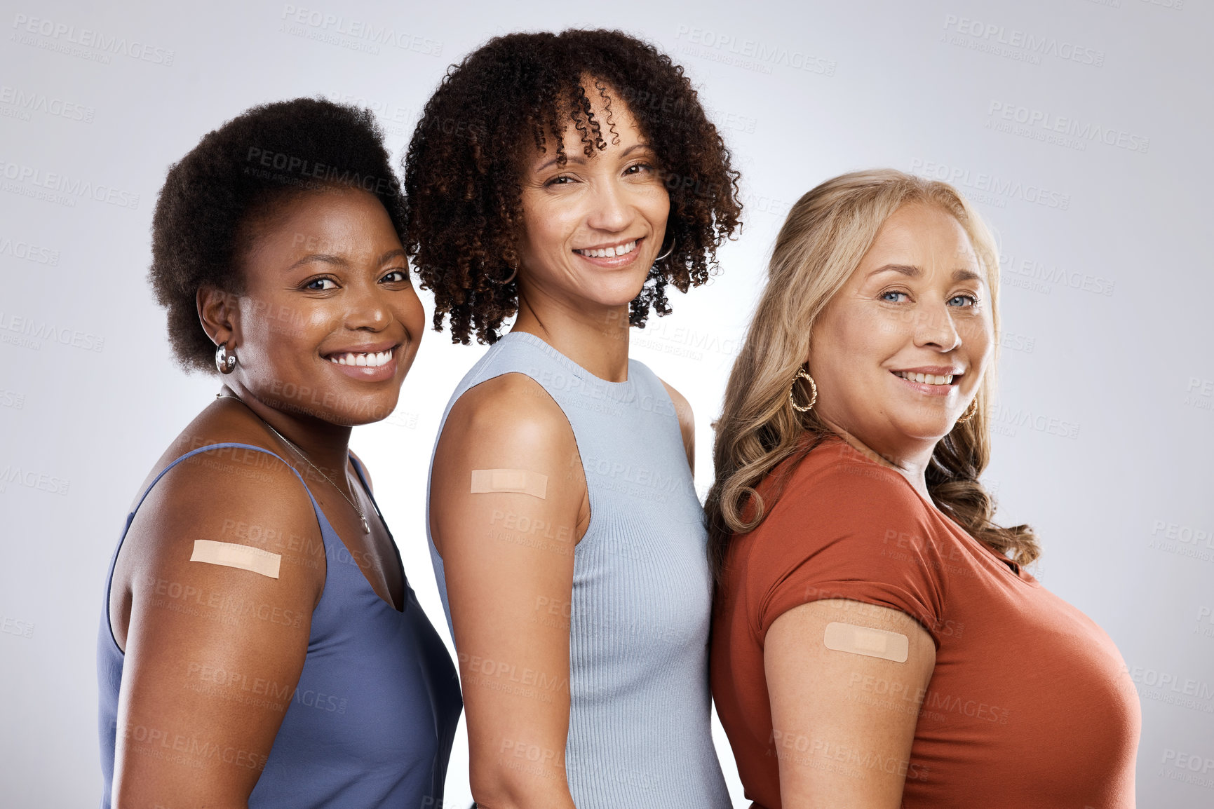 Buy stock photo Studio shot of a group of people wearing plasters after getting the Covid-19 vaccine against a grey background