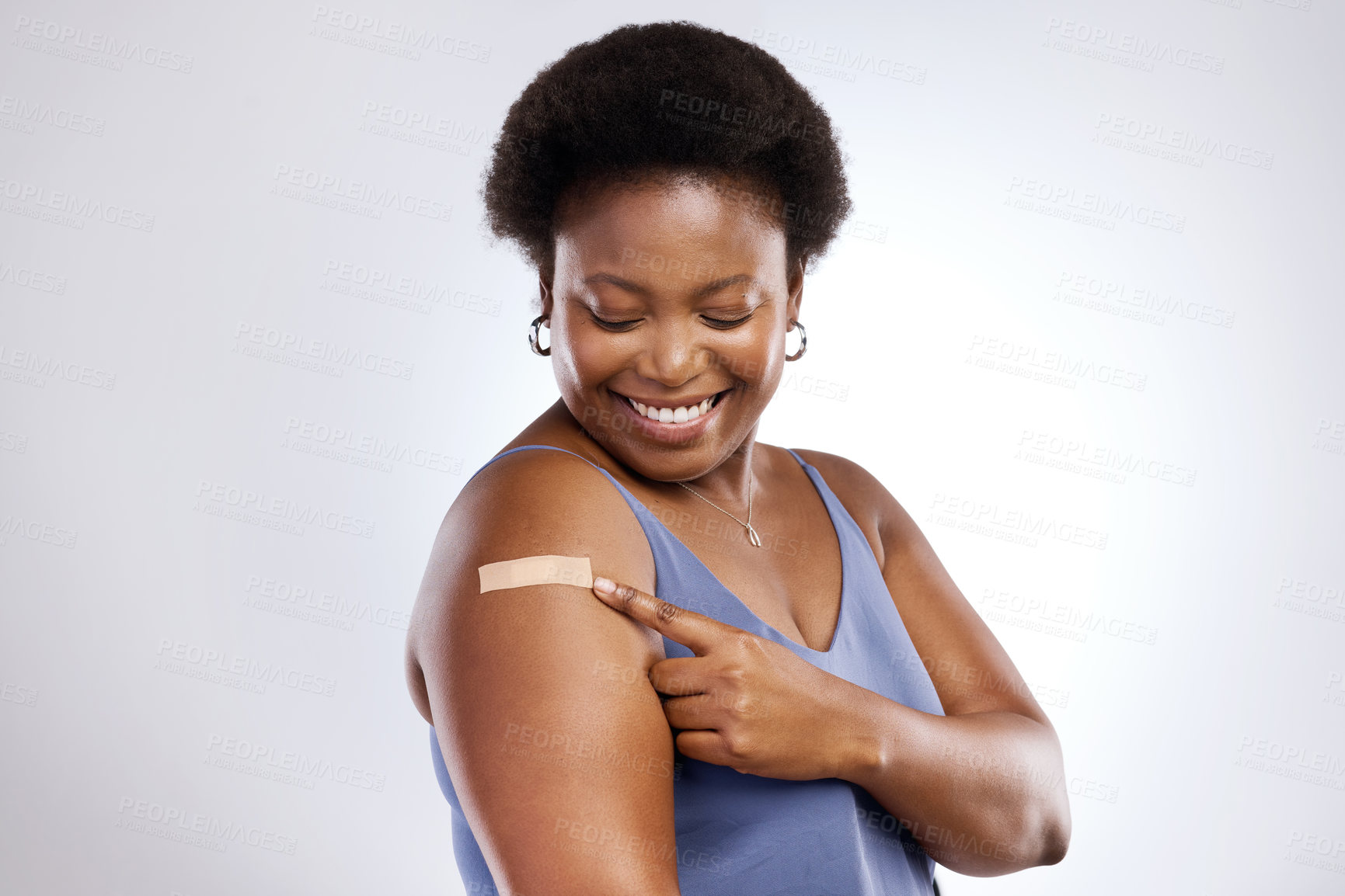 Buy stock photo Studio shot of a young woman after receiving the Covid-19 vaccine against a grey background