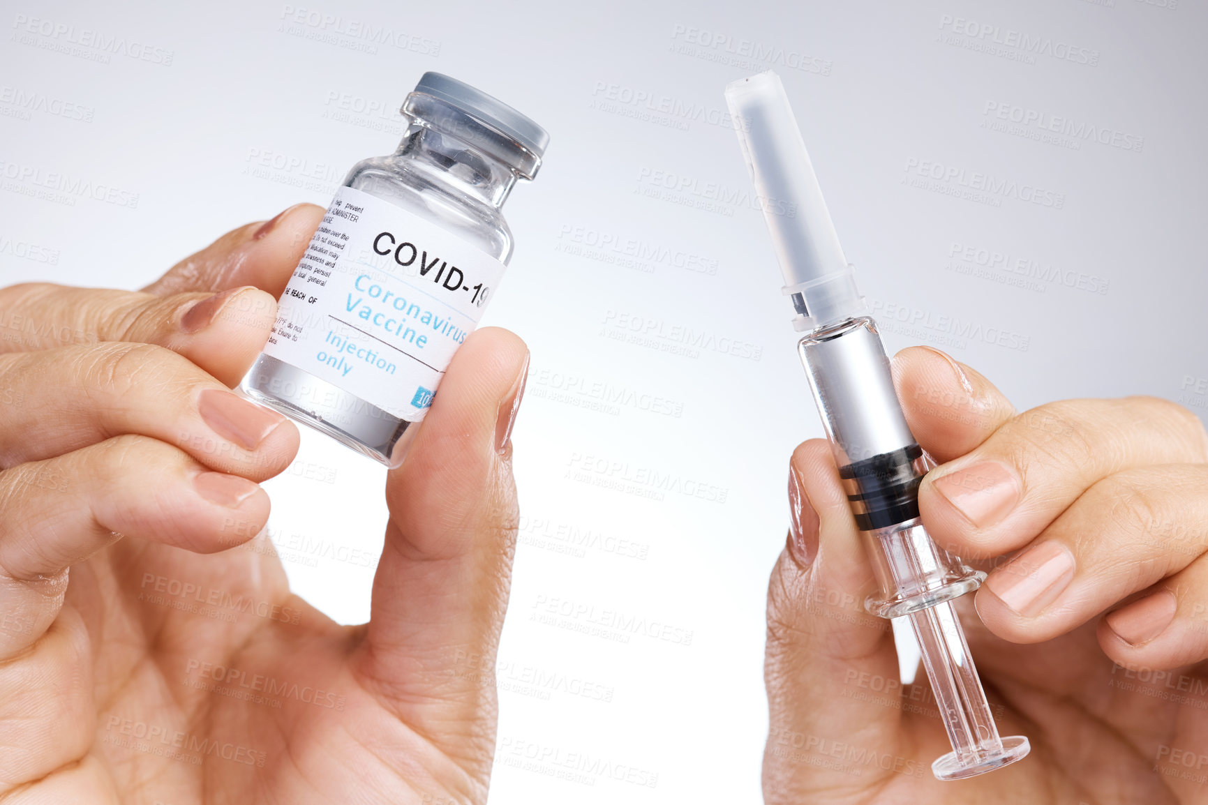 Buy stock photo Shot of a unrecognizable person holding the vaccine against a grey background