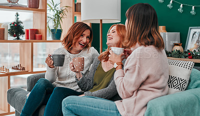 Buy stock photo Shot of three attractive women having a coffee on the sofa together at home