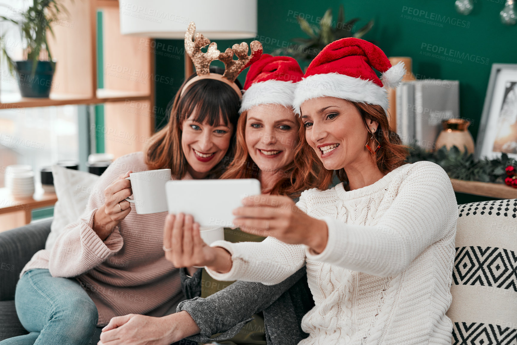 Buy stock photo Women, selfie and Christmas on couch in home for holiday, celebration and happiness with coffee. Technology, friends and group in apartment on sofa for relax, vacation and drink in lounge with smile