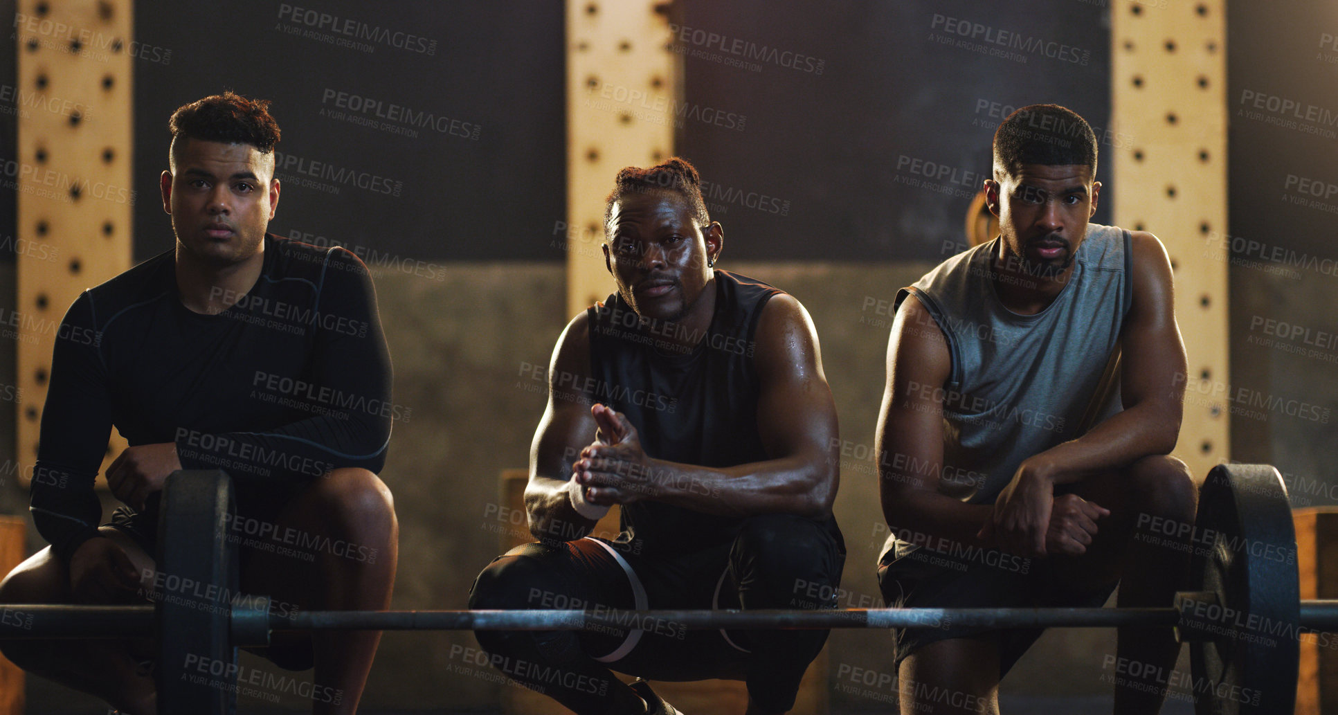 Buy stock photo Portrait of a group of muscular young men exercising together in a gym