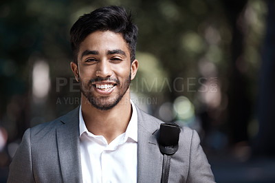 Buy stock photo Shot of a young businessman standing in the city