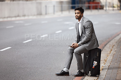 Buy stock photo Suitcase, road and businessman in the city for travel to airport for corporate company trip. Phone, bag and professional male employee sitting in urban town road waiting for a cab, taxi or transport.