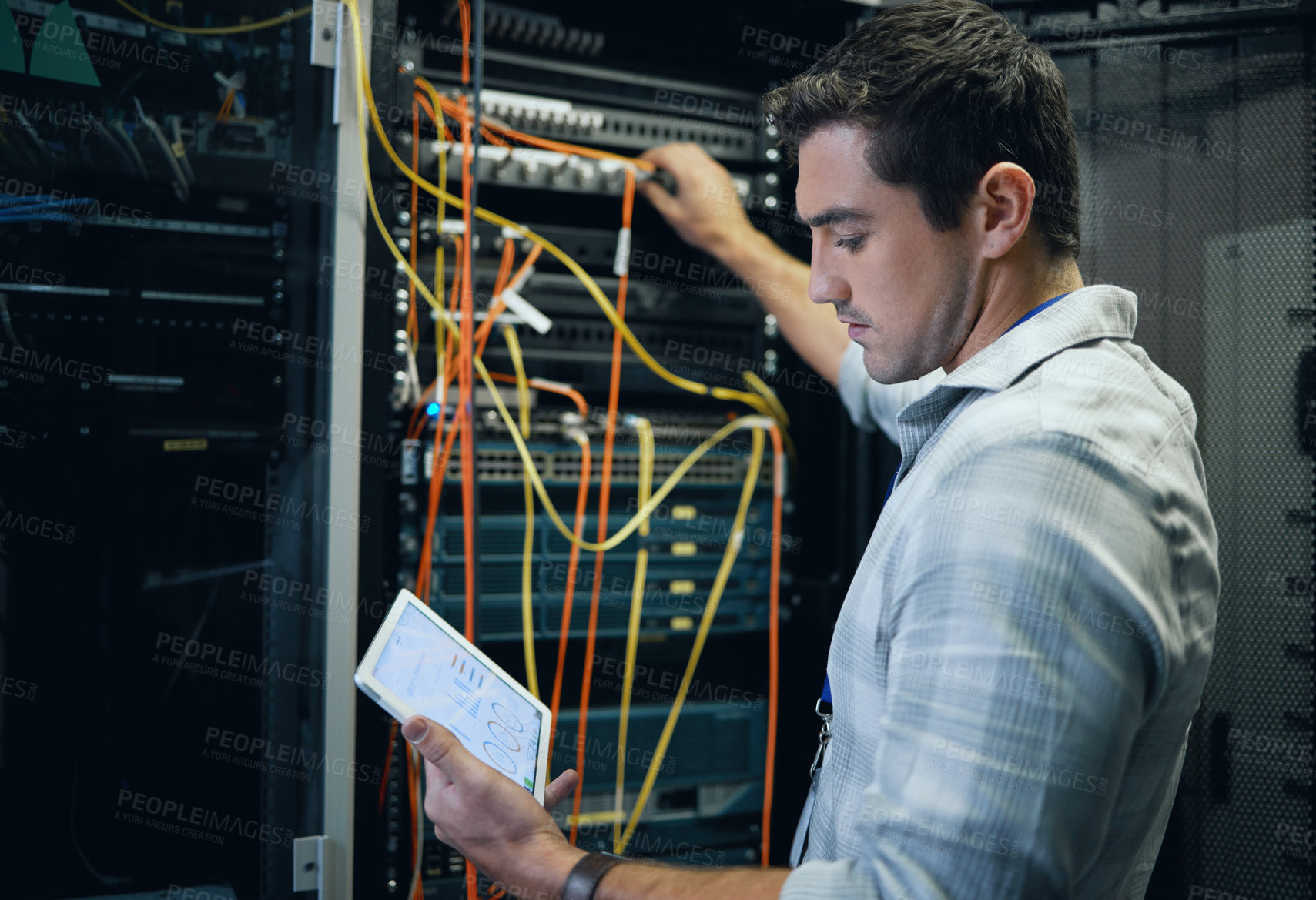 Buy stock photo Server room, engineer and man working with a tablet for programming, cybersecurity or cable maintenance. Technician person in a datacenter for network, software or system upgrade with technology app