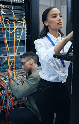 Buy stock photo Server room, engineer or IT team working together for programming, cybersecurity or maintenance. African woman and man technician in datacenter for network, software and server or system upgrade