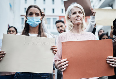 Buy stock photo Shot of a mature woman protesting the covid vaccine