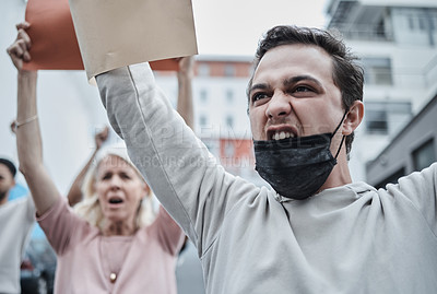 Buy stock photo Shot of a young man marching at a vaccination protest