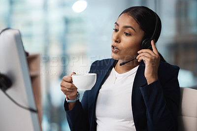 Buy stock photo Call center, customer service and coffee with a business woman using a headset while consulting at work. Support, contact us or crm with a young female employee consulting in her telemarketing office