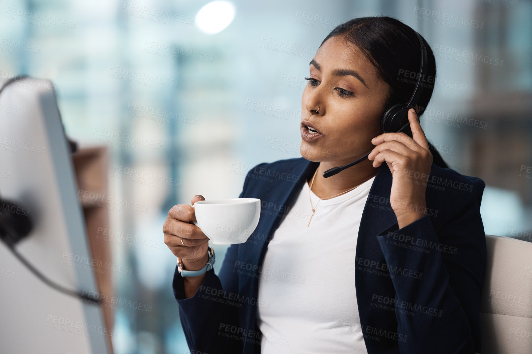 Buy stock photo Call center, customer service and coffee with a business woman using a headset while consulting at work. Support, contact us or crm with a young female employee consulting in her telemarketing office