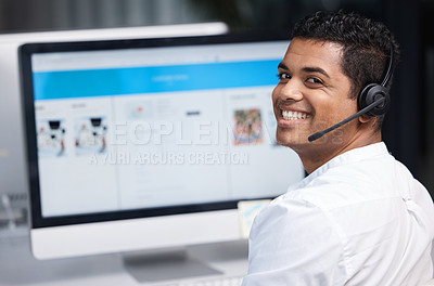 Buy stock photo Portrait of a young businessman working on a computer in a call centre