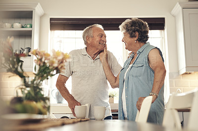 Buy stock photo Shot of a senior couple having breakfast together at home