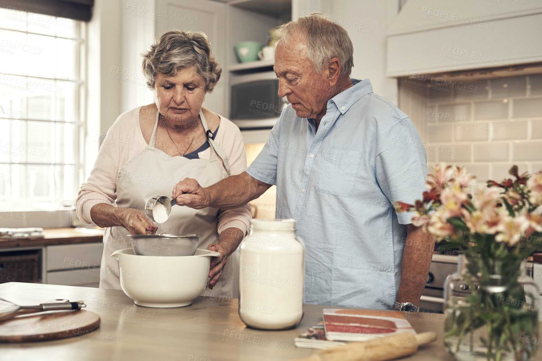 Buy stock photo Shot of a senior couple baking together at home