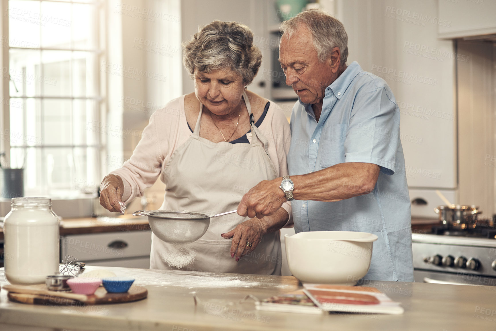 Buy stock photo Shot of a senior couple baking together at home