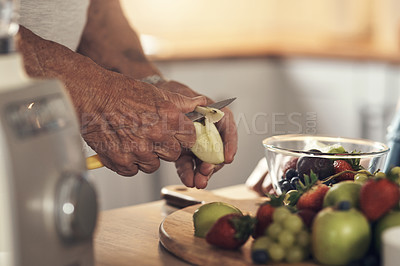 Buy stock photo Shot of an unrecognizable person preparing ingredients for a smoothie at home
