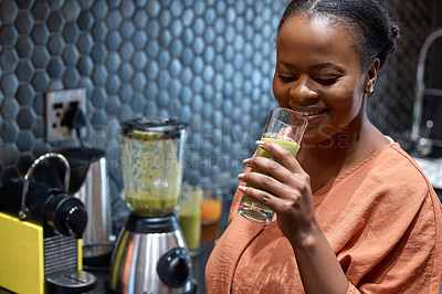 Buy stock photo Shot of a young woman making a healthy smoothie at home