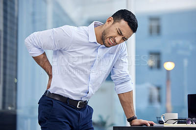 Buy stock photo Shot of a businessman suffering from backache at work