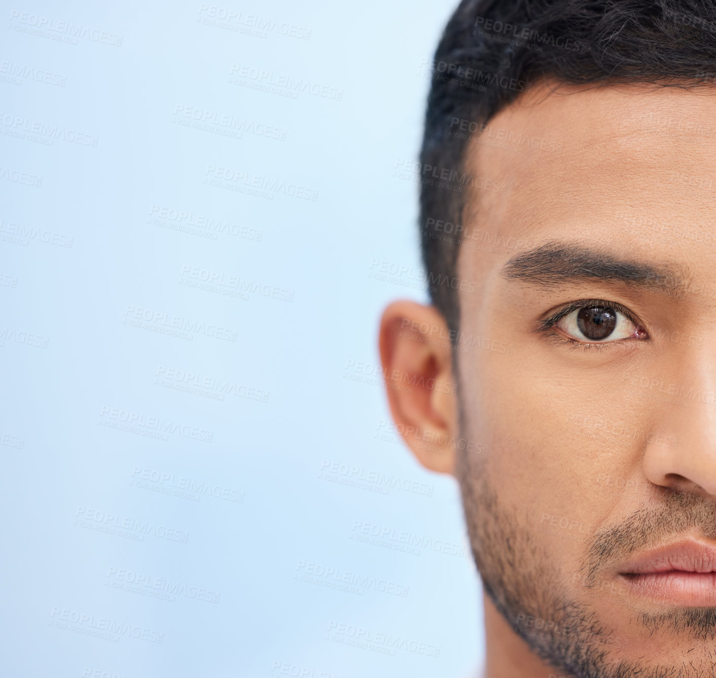 Buy stock photo Cropped shot of a young businessman standing alone in the office during the day