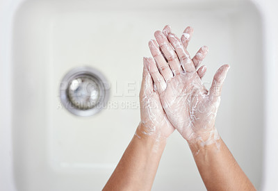 Buy stock photo Shot of an unrecognizable person washing their hands at home