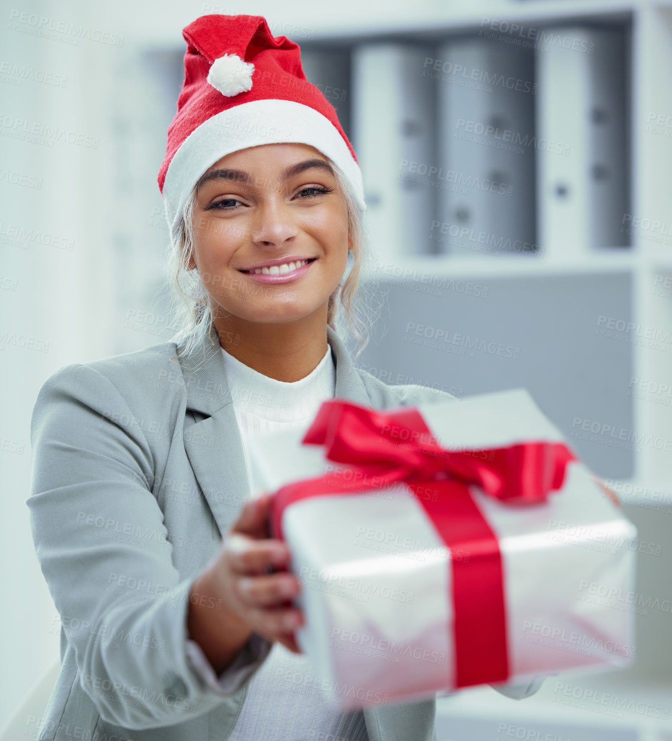 Buy stock photo Portrait of a young beautiful woman spreading Christmas cheer with gifts at the office