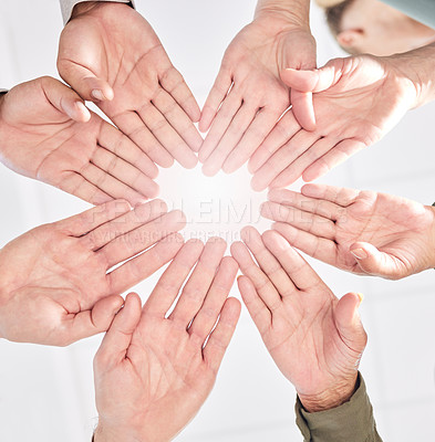 Buy stock photo Shot of a group of business people with their hands together in a circle
