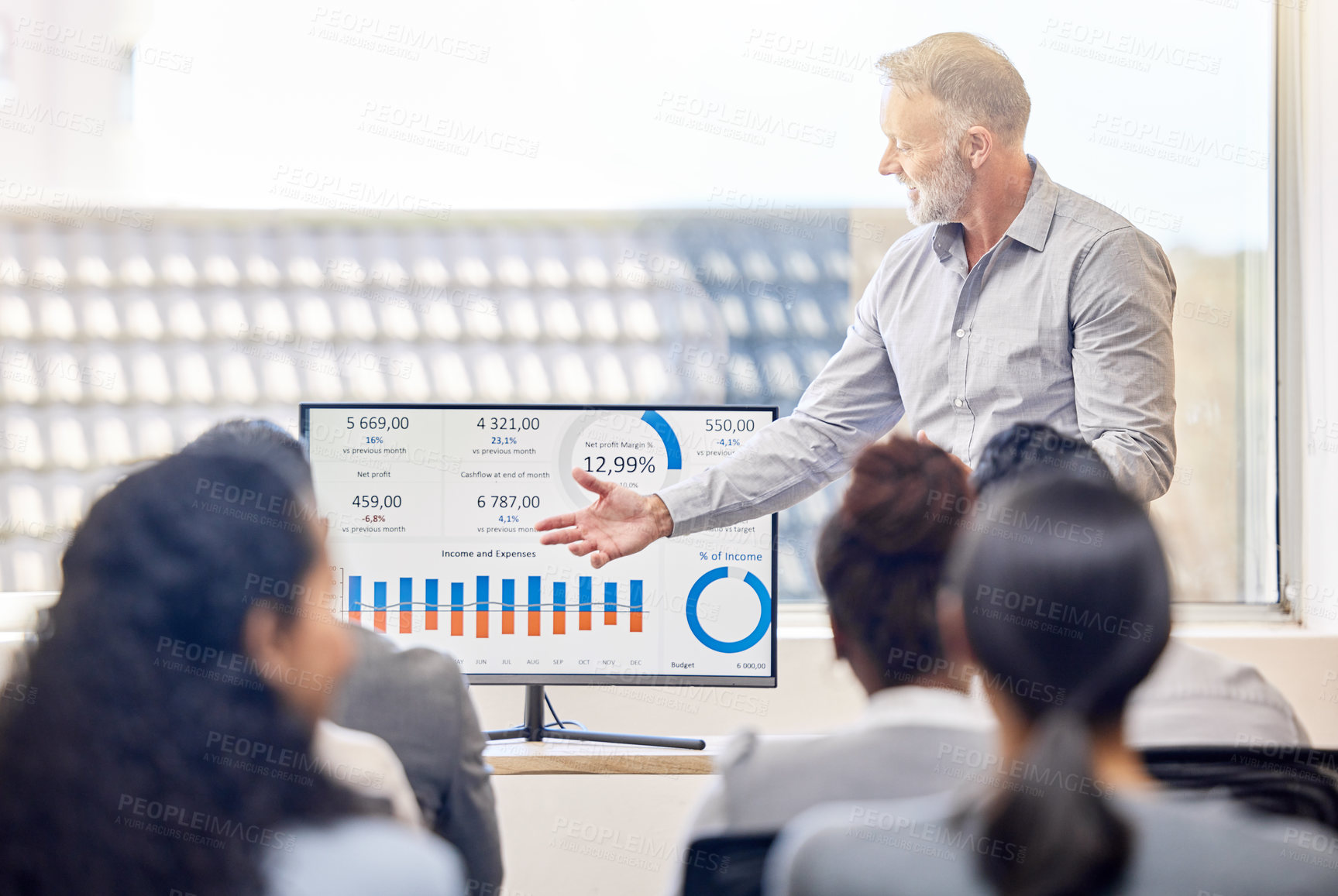 Buy stock photo Cropped shot of a handsome mature businessman giving a presentation in the conference room