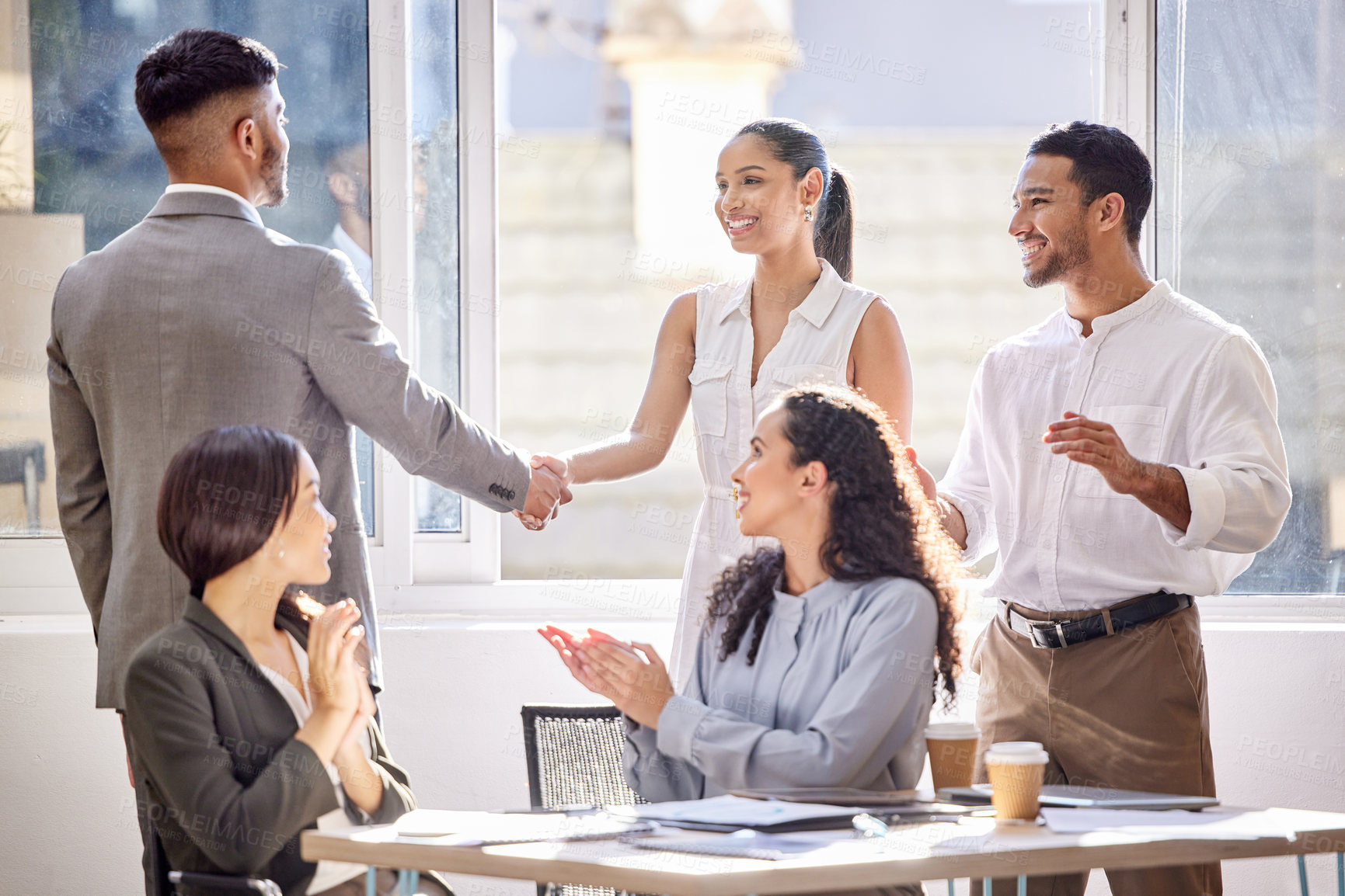 Buy stock photo Shot of two businesspeople shaking hands during a meeting in an office