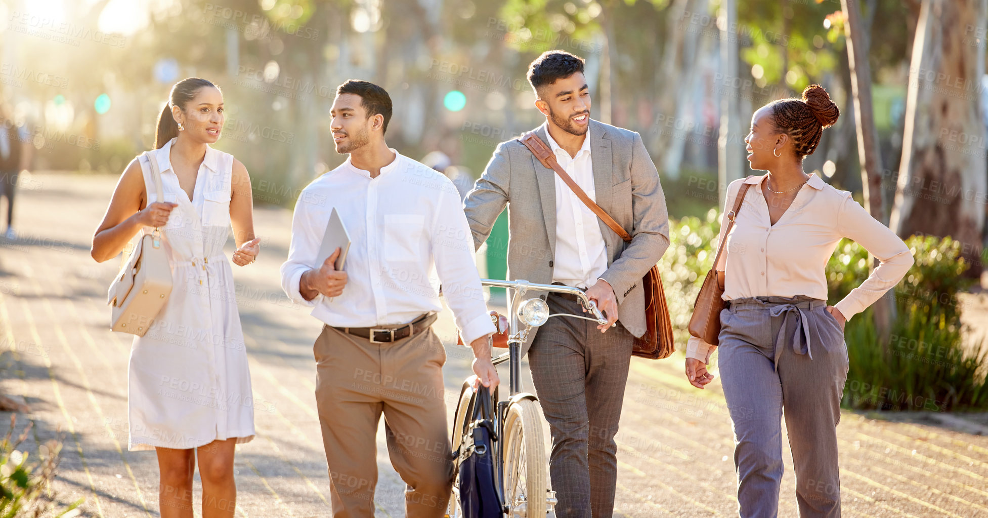 Buy stock photo Shot of a diverse group of businesspeople walking through the city together after work