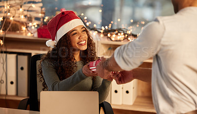 Buy stock photo Shot of two young businesspeople celebrating Christmas at work