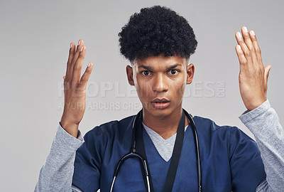 Buy stock photo Shot of a male nurse looking confused while standing against a grey background