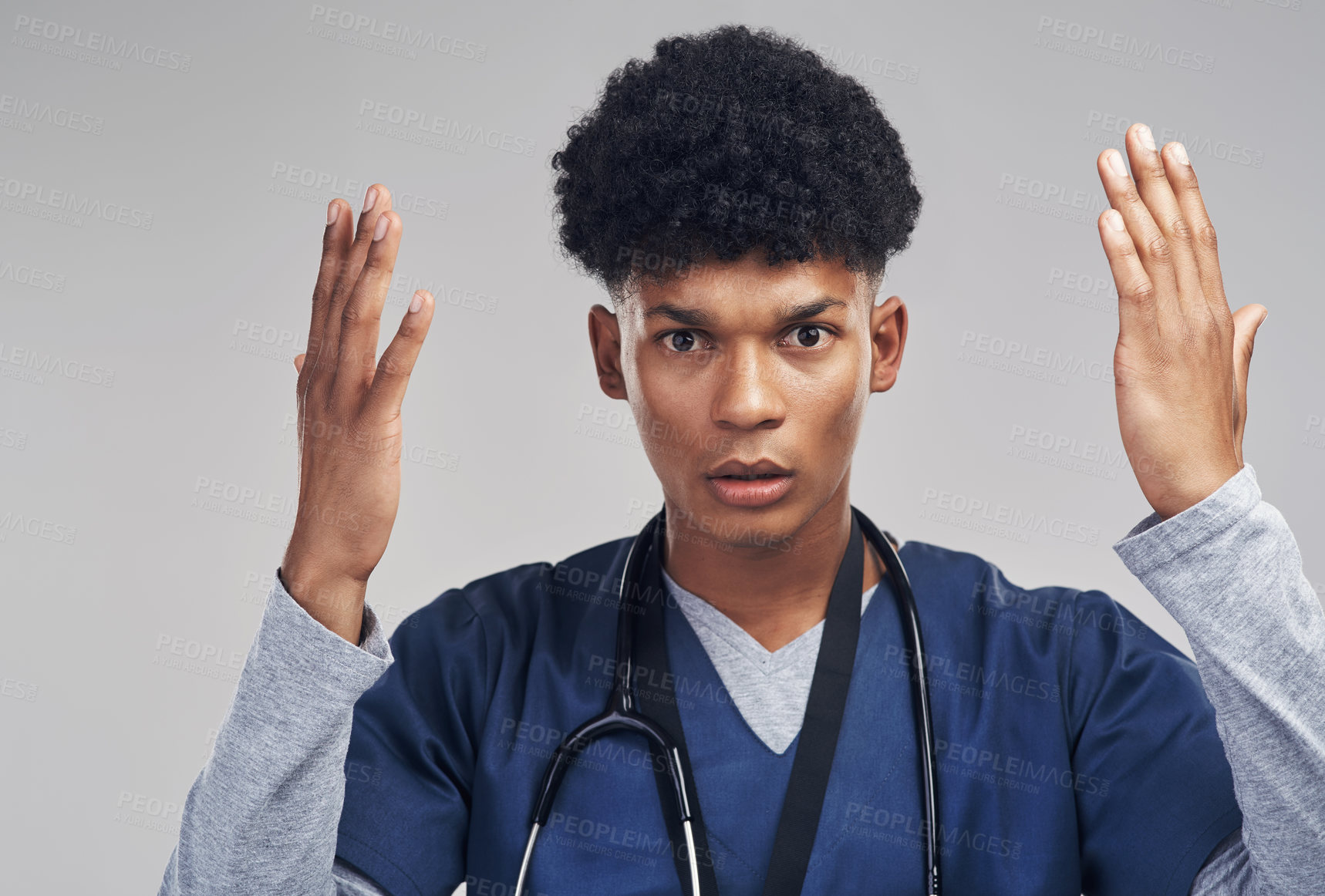 Buy stock photo Shot of a male nurse looking confused while standing against a grey background